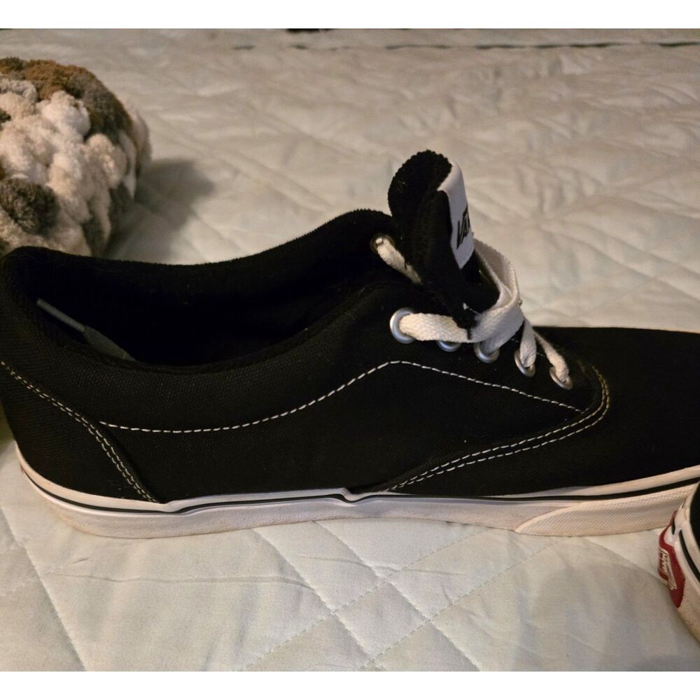 These are black Vans Authentic sneakers with white laces. - Picture 7 of 9